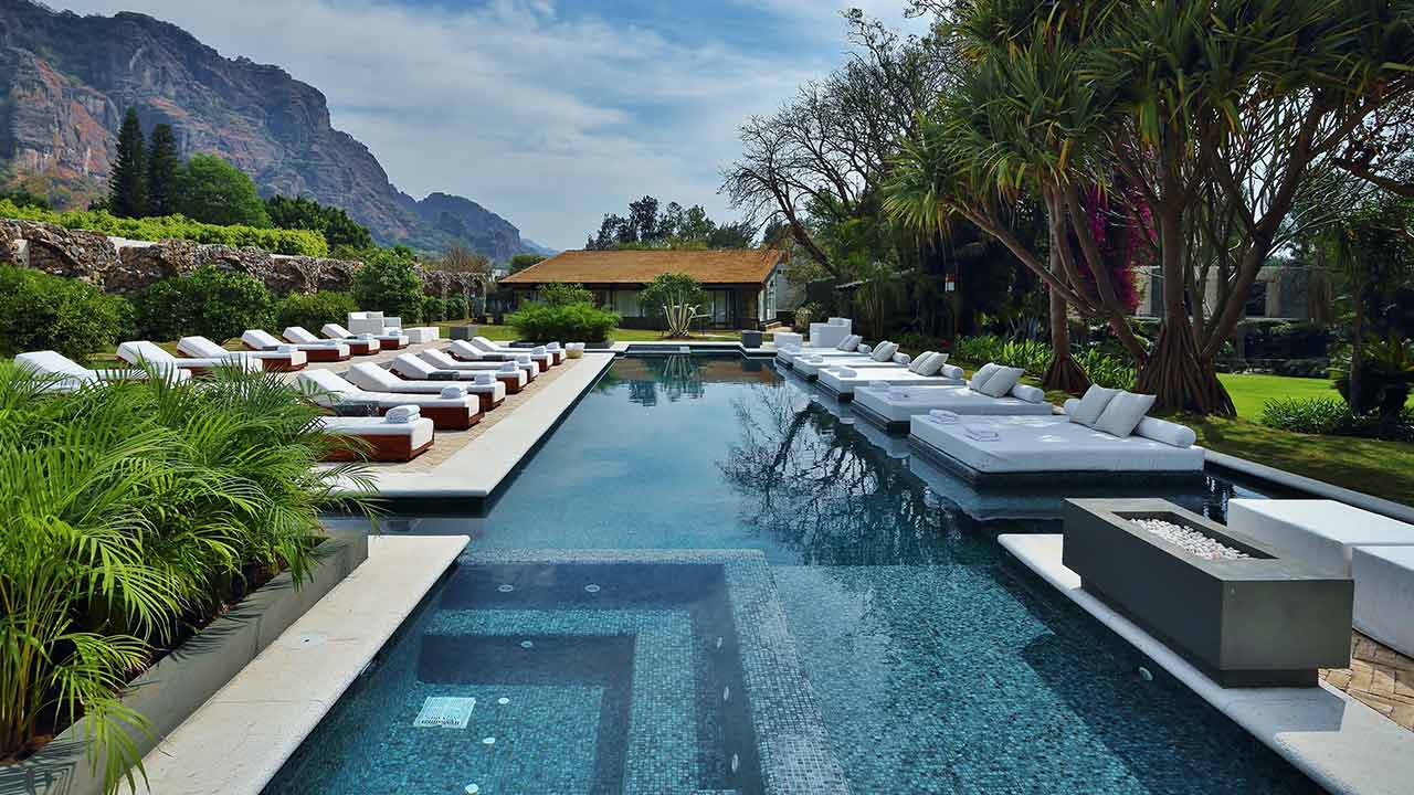 Luxury wellness experience at Amomoxtli pool with Tepozteco mountain view in Tepoztlán by Onedaytrip Mexico City